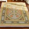 Modern abstract miniature rug with bold patterns in pink, black, blue, and green.