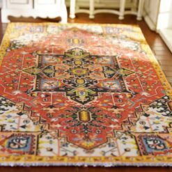 Miniature Persian rug with a red base, floral medallion, and intricate detailing.