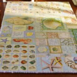 Miniature coastal rug with nautical motifs like lighthouses, starfish, and anchors.