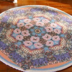 Miniature oriental rug with a colorful floral medallion and intricate detailing.