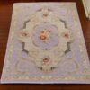 Victorian style miniature rug with purple background and floral accents