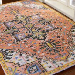 Persian style miniature rug with orange, black, and geometric floral patterns
