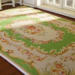 Miniature Aubusson rug with floral medallion and green background