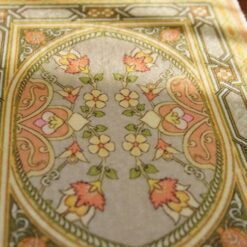 Modern abstract miniature rug with bold patterns in pink, black, blue, and green.