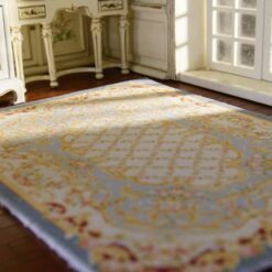 Miniature Aubusson-style rug in pastel blue with floral borders and intricate detailing.