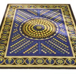 Geometric miniature rug with a spiral pattern of blue and yellow dots, bordered with floral accents.