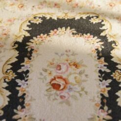 Aubusson style miniature rug in black with intricate floral motifs