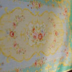 Victorian style miniature rug with turquoise and yellow floral motifs