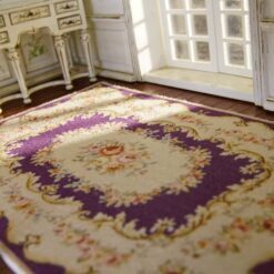 ubusson style miniature rug in purple with floral motifs and delicate detailing