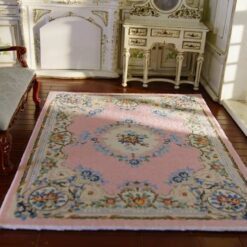 Victorian-style miniature rug with pink background and floral medallion