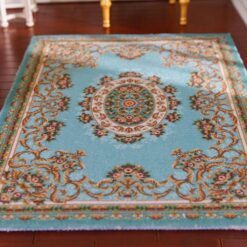 Miniature rug with a blue background and floral medallion, accented with scrollwork and floral details.