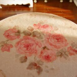 Miniature shabby chic rug with a pink rose bouquet and soft floral details.