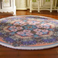 Miniature oriental rug with a colorful floral medallion and intricate detailing.