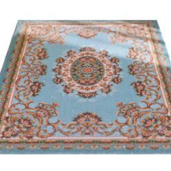 Miniature rug with a blue background and floral medallion, accented with scrollwork and floral details.