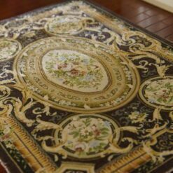 French Aubusson Floral Miniature Rug 12 French Aubusson miniature rug with floral medallions and gold scroll designs on a dark brown background.