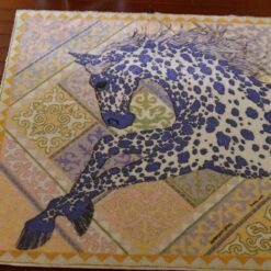 Miniature rug with a running horse design in purple, yellow, and pink tones with intricate detailing.