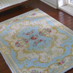 Victorian style miniature rug in light blue and yellow with floral accents