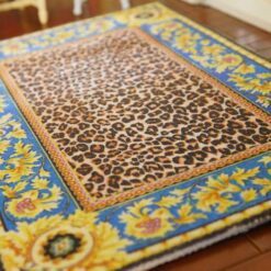Miniature dollhouse rug with leopard print center and golden sunflower border
