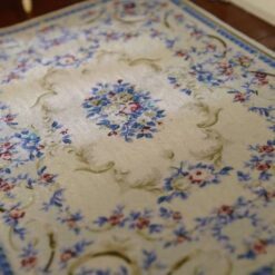 Miniature dollhouse rug with blue and pink floral Aubusson design