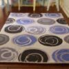 Modern miniature dollhouse rug with blue and gray circular pattern