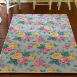 Miniature dollhouse rug with pink and yellow roses on mint background