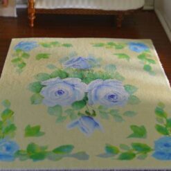 Yellow background miniature rug with blue roses and green leaves