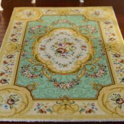 French Aubusson floral rug with green background and gold trim