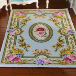 Elegant Blue Victorian Floral Rug for Dollhouses 11 Victorian-style miniature rug with light blue background and floral roses, featuring scrolls and a central medallion.