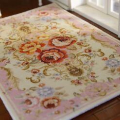 Pink miniature rug with floral scrolls and roses, perfect for adding a romantic touch to any dollhouse.