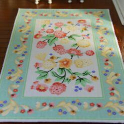 Pastel floral miniature rug featuring a colorful bouquet of flowers in pink, yellow, and green
