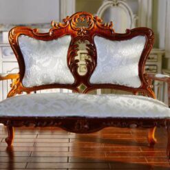 Victorian-style miniature loveseat with carved details and luxurious cushion
