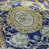 Royal Aubusson miniature rug featuring floral medallions and intricate scrolls in blue and cream