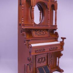 Victorian-style miniature wooden organ with mirror and carvings