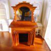 Victorian-style miniature fireplace with mahogany finish and mirror