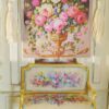 Miniature Aubusson tapestry featuring pastel roses in a golden urn with lush greenery.