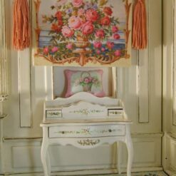Golden urn filled with roses and flowers set against an ocean backdrop, a miniature Aubusson tapestry.
