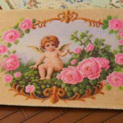 Cherub surrounded by pink roses and ornate golden details, a miniature Aubusson tapestry.