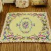 Elegant square Victorian miniature rug with floral details in soft pastel colors, perfect for your dollhouse.