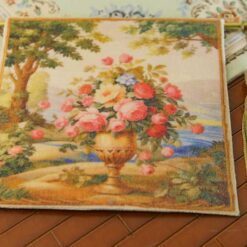 Bouquet of roses and wildflowers in a golden vase against a garden landscape, a miniature Aubusson tapestry.