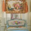 Miniature Aubusson tapestry featuring a golden urn with pastel roses framed by intricate scrollwork.