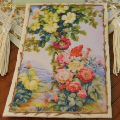 Wildflower bouquet and roses climbing a trellis in soft pastel hues, a miniature Aubusson tapestry.