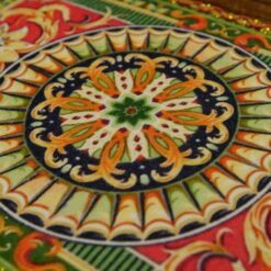 A unique Aubusson miniature rug featuring a floral medallion in rich, warm tones, ideal for vintage dollhouses.