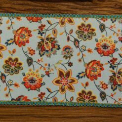Miniature modern floral rug with bright colors and intricate flower patterns.