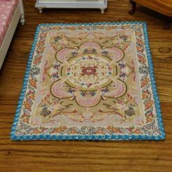 Miniature Aubusson rug with soft floral pattern and pastel borders.