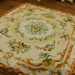 Miniature Victorian rug with floral design in muted tones.