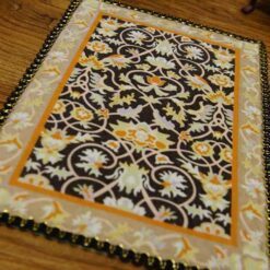 Miniature modern Persian rug with floral design and elegant colors.