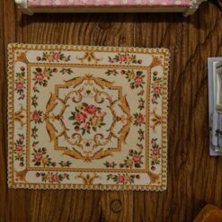 Miniature red and yellow Victorian rug with rose and scroll design.