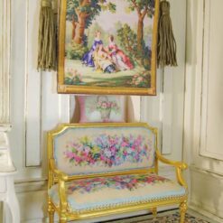 Miniature Aubusson tapestry with three figures in a forest setting, surrounded by trees and delicate blossoms.