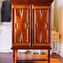 This walnut wardrobe for dollhouses features intricate carvings, double doors, and a polished finish, perfect for adding elegance to Vintage-style interiors. 10 Vintage miniature walnut wardrobe with carved details