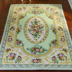 Green Victorian floral rug with gold and pink accents